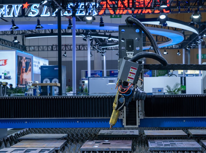 A CNC laser machine operating in a high-tech industrial exhibition setup with vibrant lighting